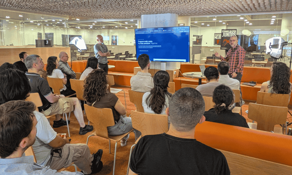 Dos ponentes imparten una sesión formativa ante un grupo de asistentes, con una presentación en pantalla.